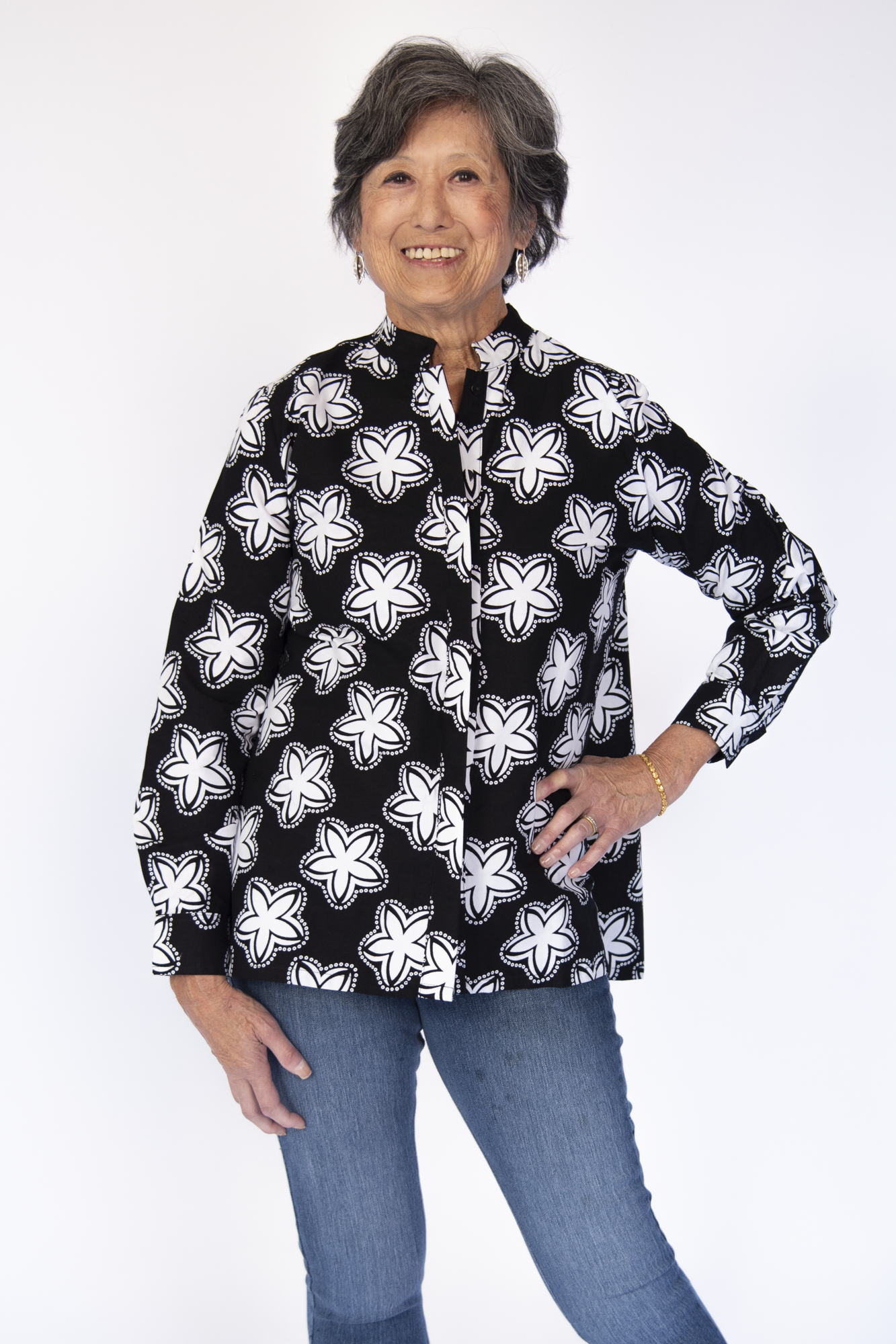 Model wearing black and white flower print shirt.
