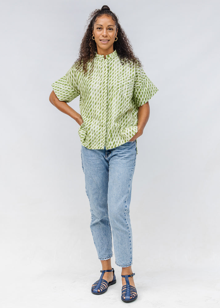 Model wearing green and white plaid shirt.