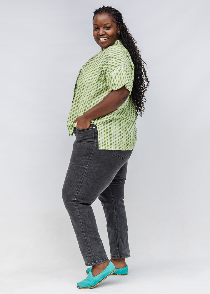 Model wearing green and white plaid shirt.