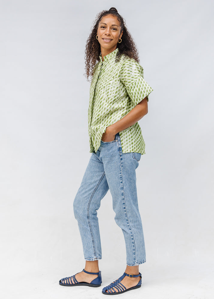 Model wearing green and white plaid shirt.