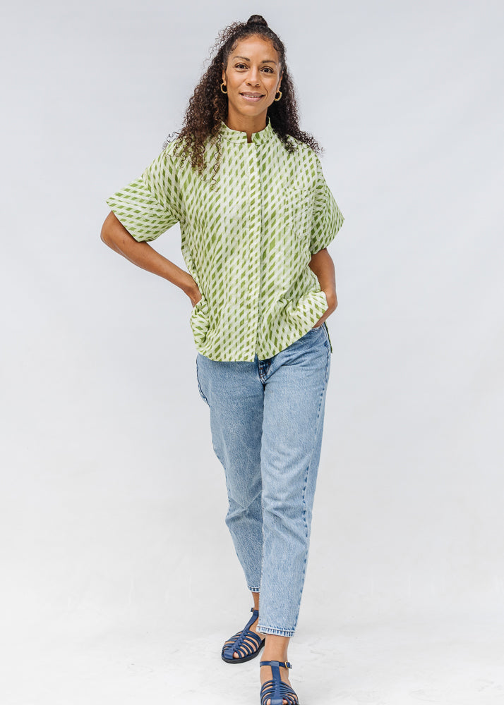 Model wearing green and white plaid shirt.