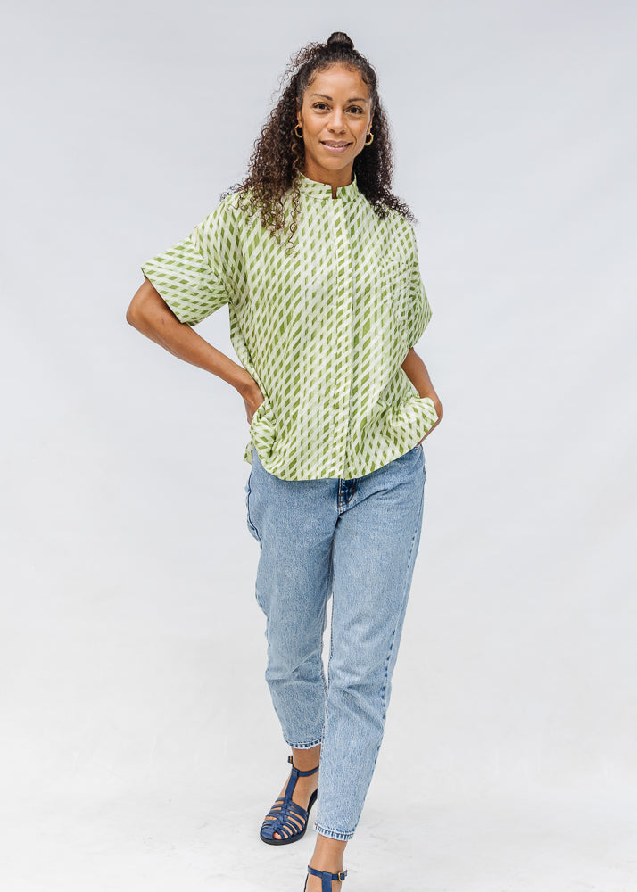 Model wearing green and white plaid shirt.