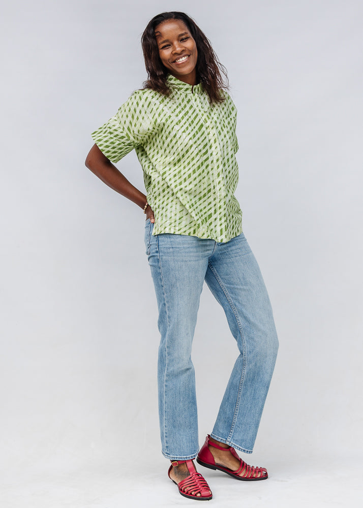 Model wearing green and white plaid shirt.