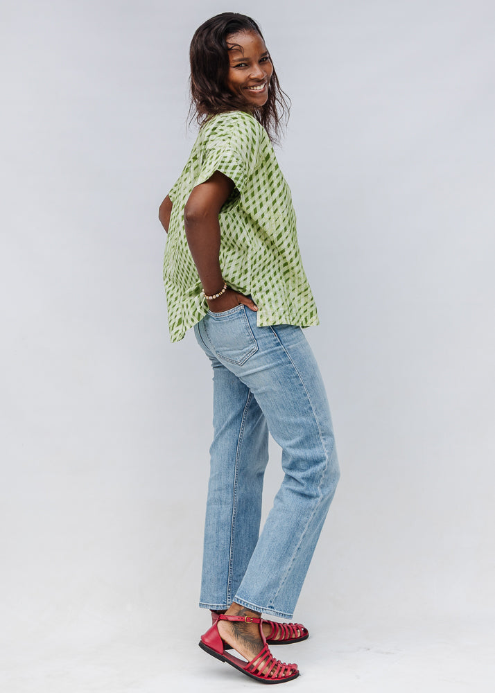 Model wearing green and white plaid shirt.