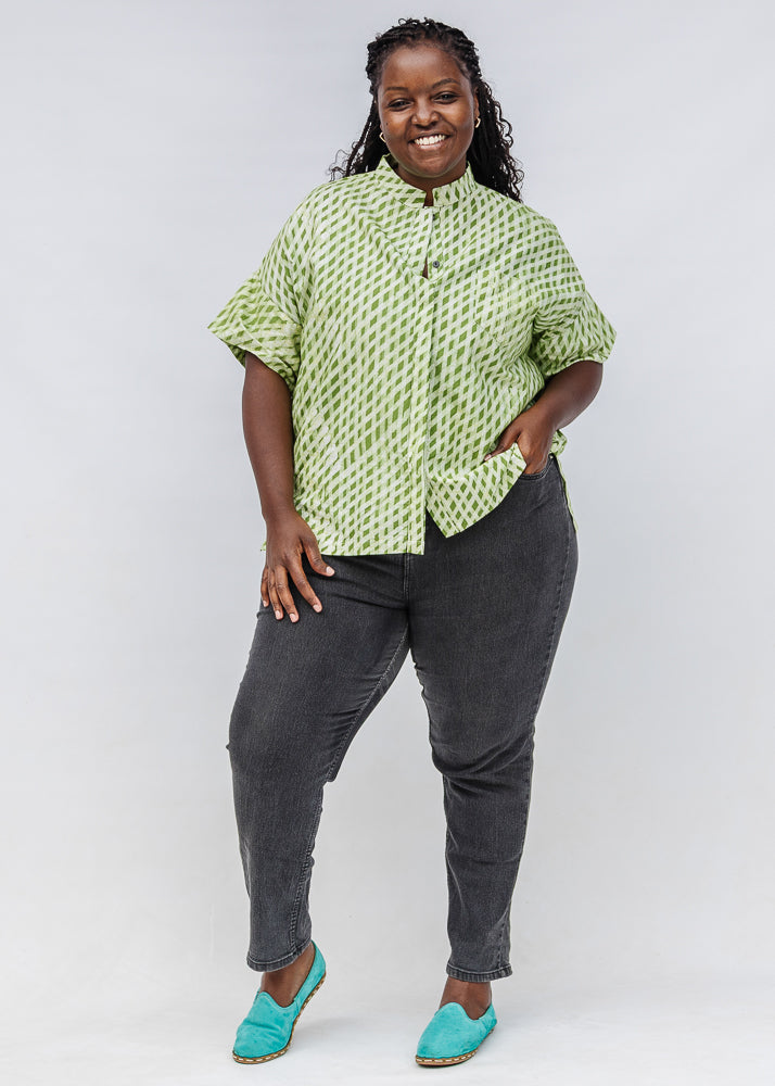 Model wearing green and white plaid shirt.