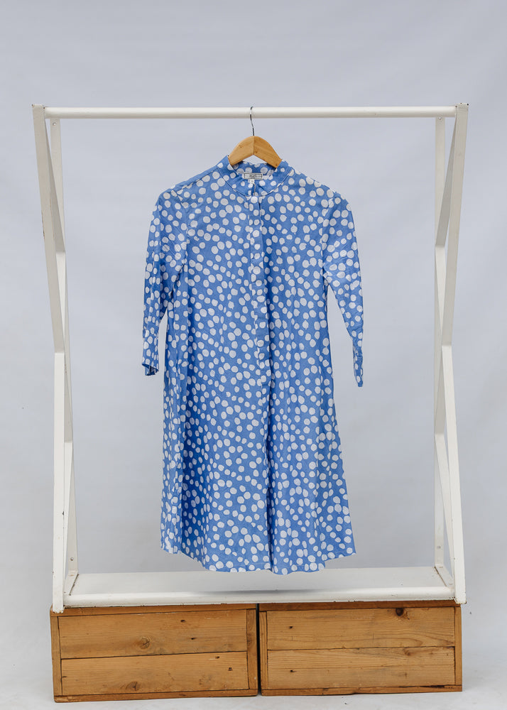Display of blue dress with white polka dots.