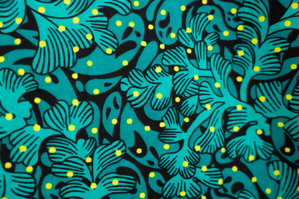 Close up display of teal floral maxi dress, fabric.