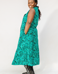 Model wearing teal floral maxi dress.
