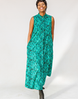 Model wearing teal floral maxi dress.