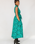 Model wearing teal floral maxi dress.