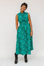 Model wearing teal floral maxi dress.