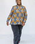 Model wearing of blue, white and yellow abstract print shirt.