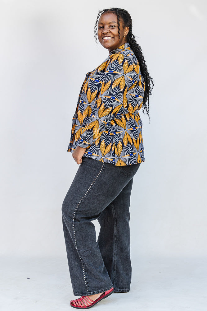 Model wearing of blue, white and yellow abstract print shirt.