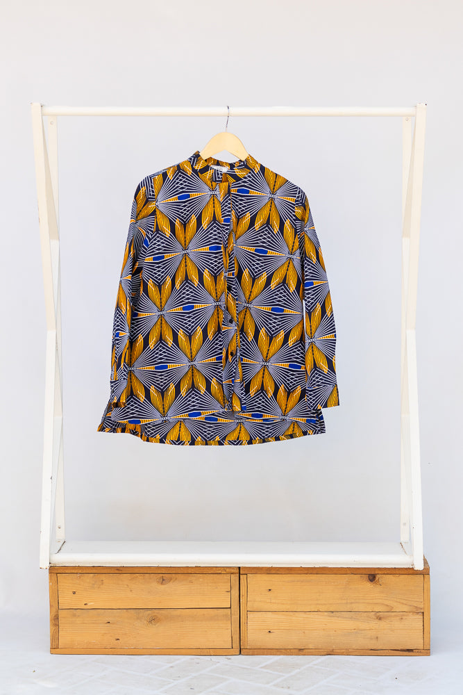 Display of blue, white and yellow abstract print shirt.