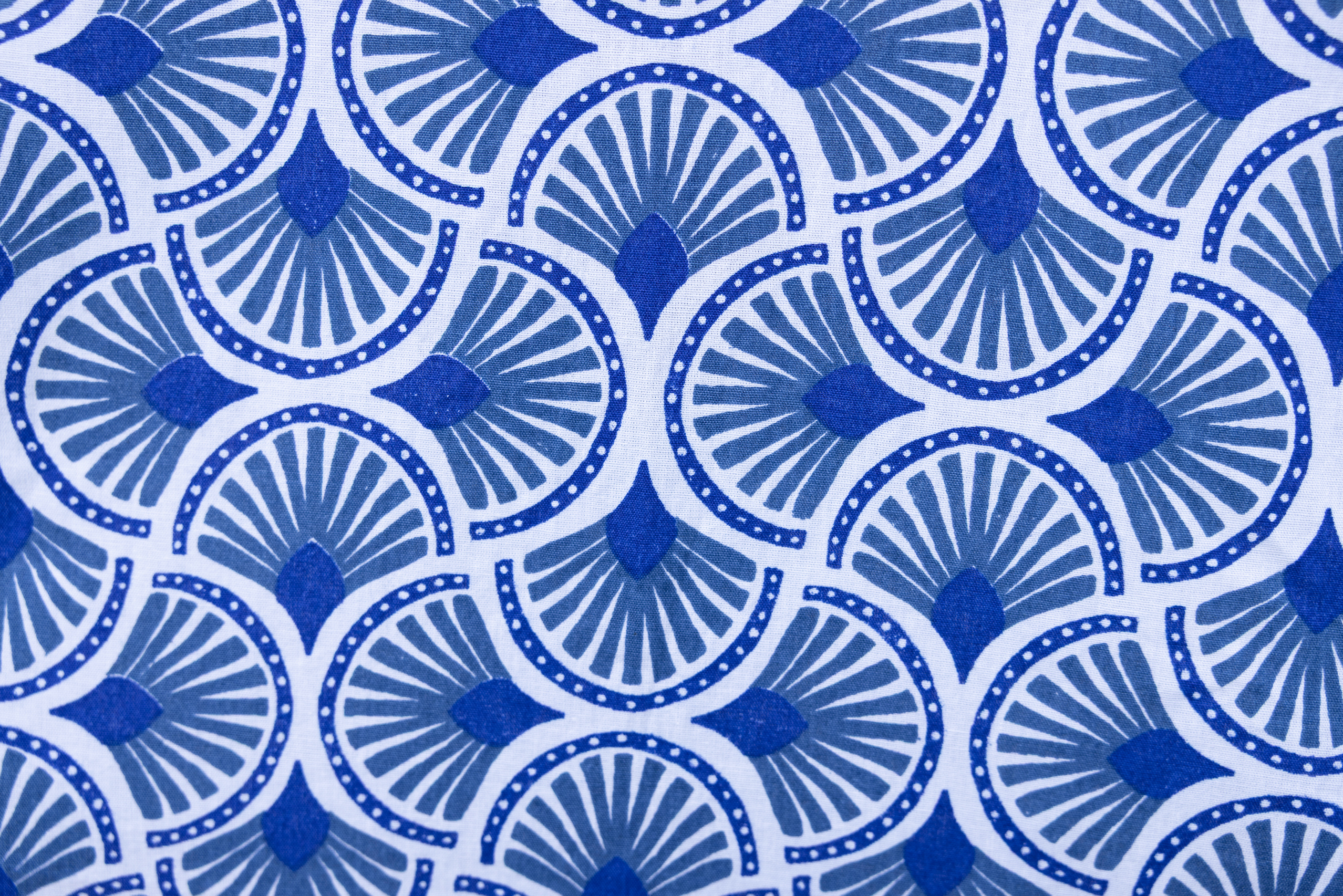Close up display of blue and white mosaic print dress, fabric.