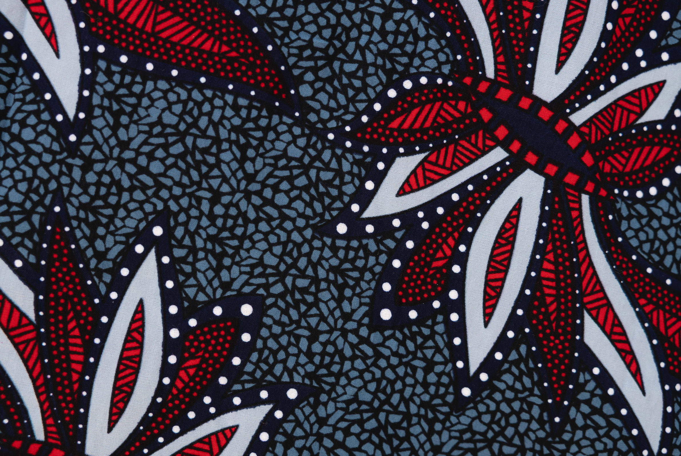 Close up display of grey, red and black dragonfly print dress, fabric.