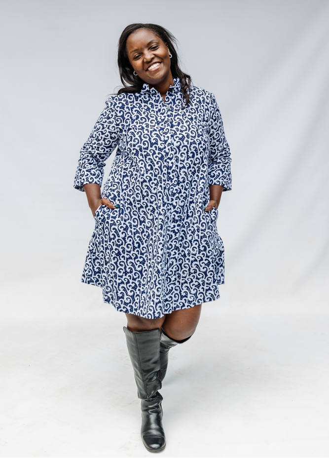 Model wearing blue and white swirl print dress.