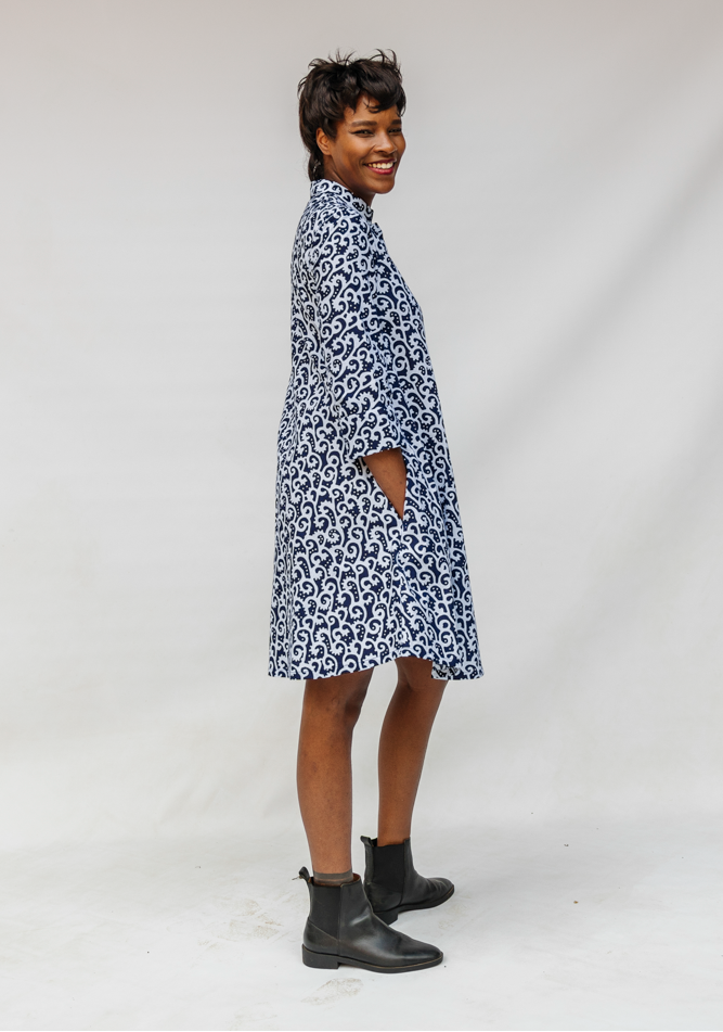 Model wearing blue and white swirl print dress.