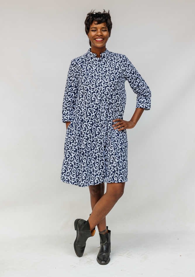 Model wearing blue and white swirl print dress.