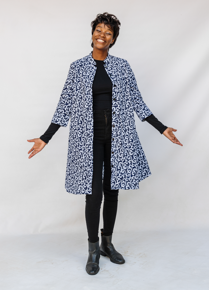 Model wearing blue and white swirl print dress.