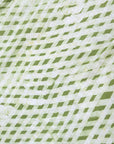 Close up display of green and white plaid shirt, fabric.