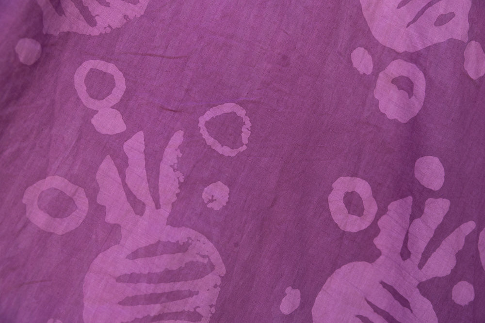 Close up display of purple dress with pink beet print, fabric.