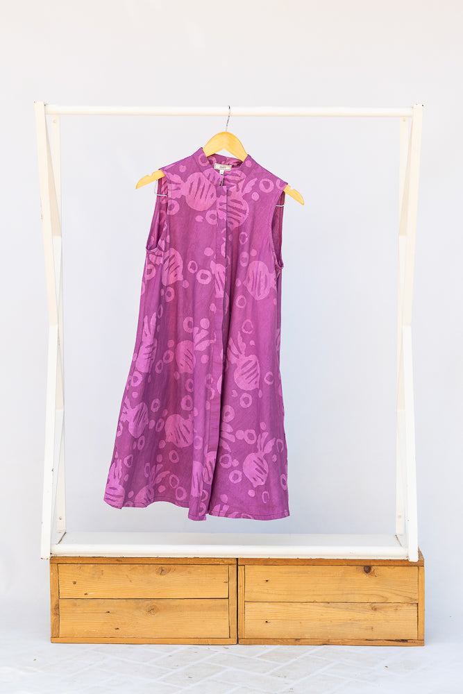 Display of purple dress with pink beet print.