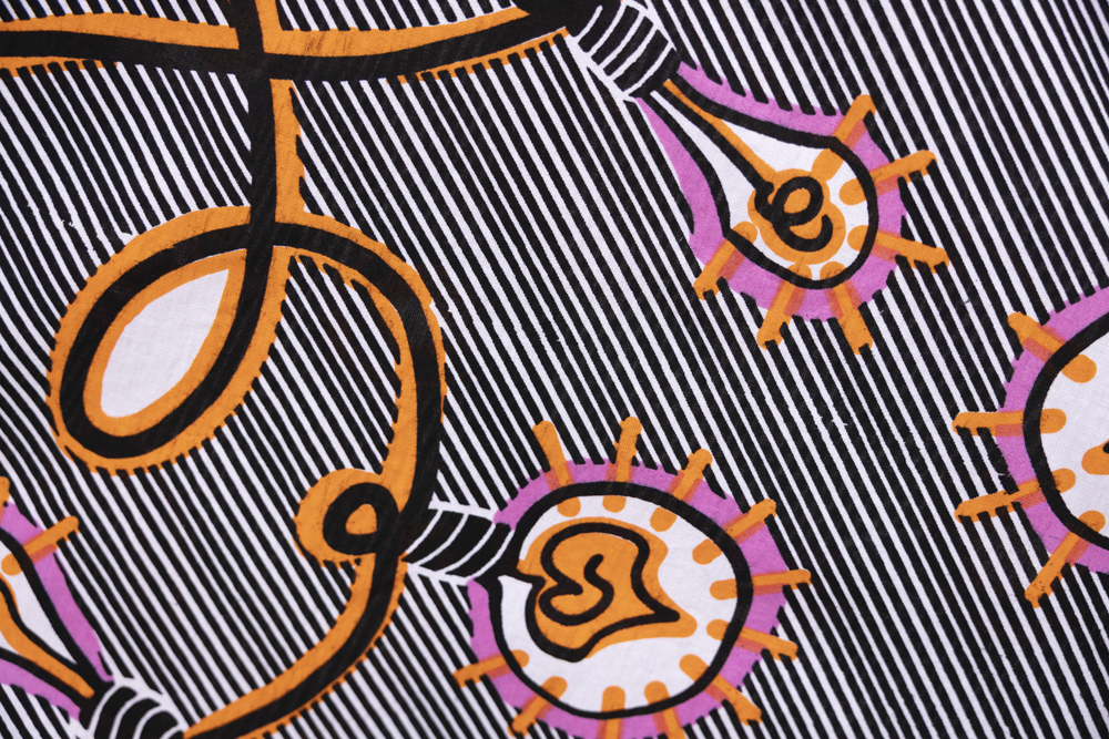 Close up display of black and white light bulb print dress, fabric.