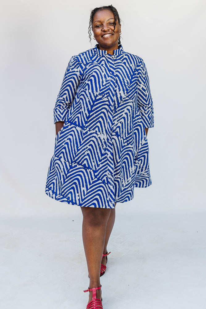 Model wearing blue and white zigzag print dress.