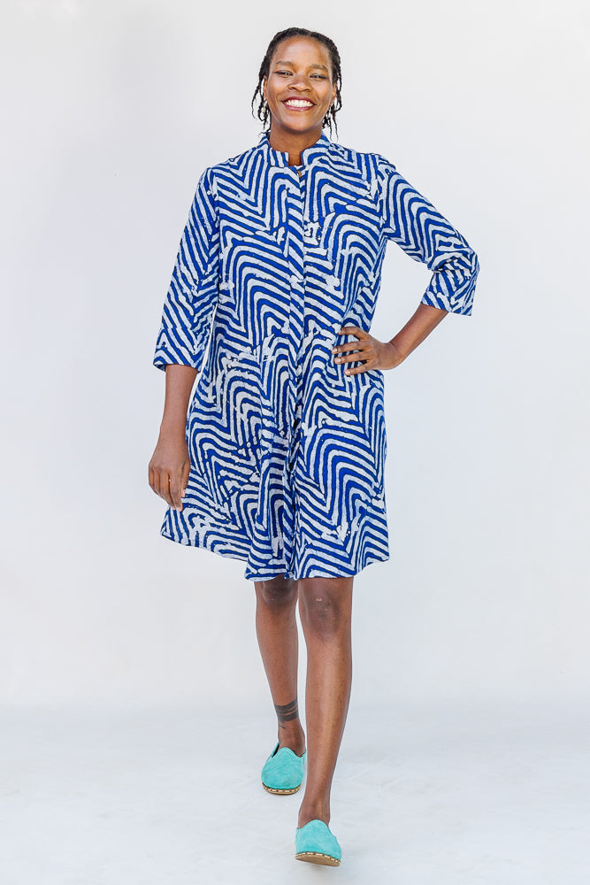 Model wearing blue and white zigzag print dress.