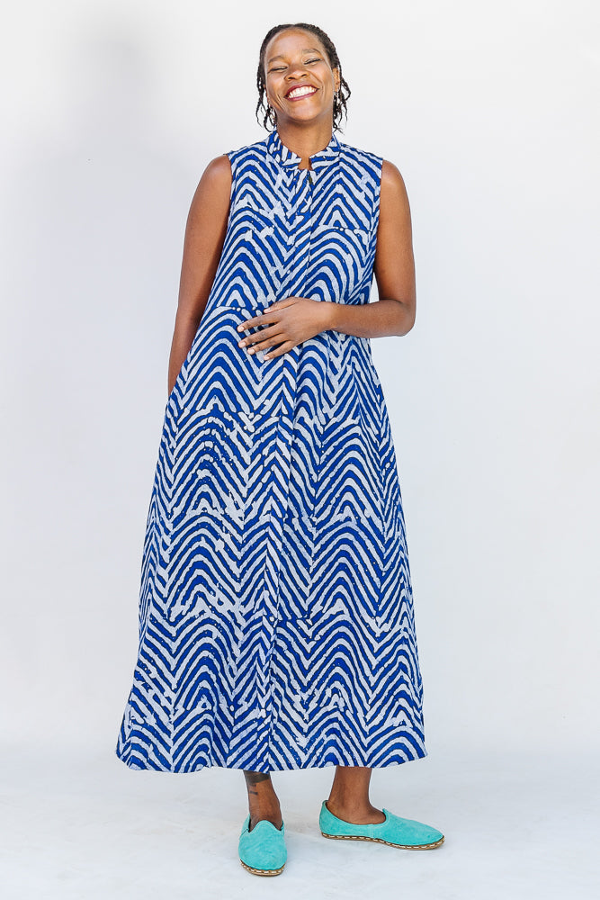 Model wearing blue and white sleeveless dress.