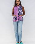 Model wearing purple, pink and white geometric print, patchwork sleeveless shirt.