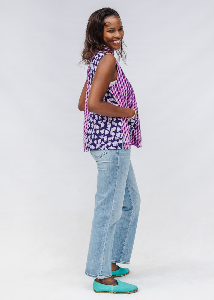 Model wearing purple, pink and white geometric print, patchwork sleeveless shirt.