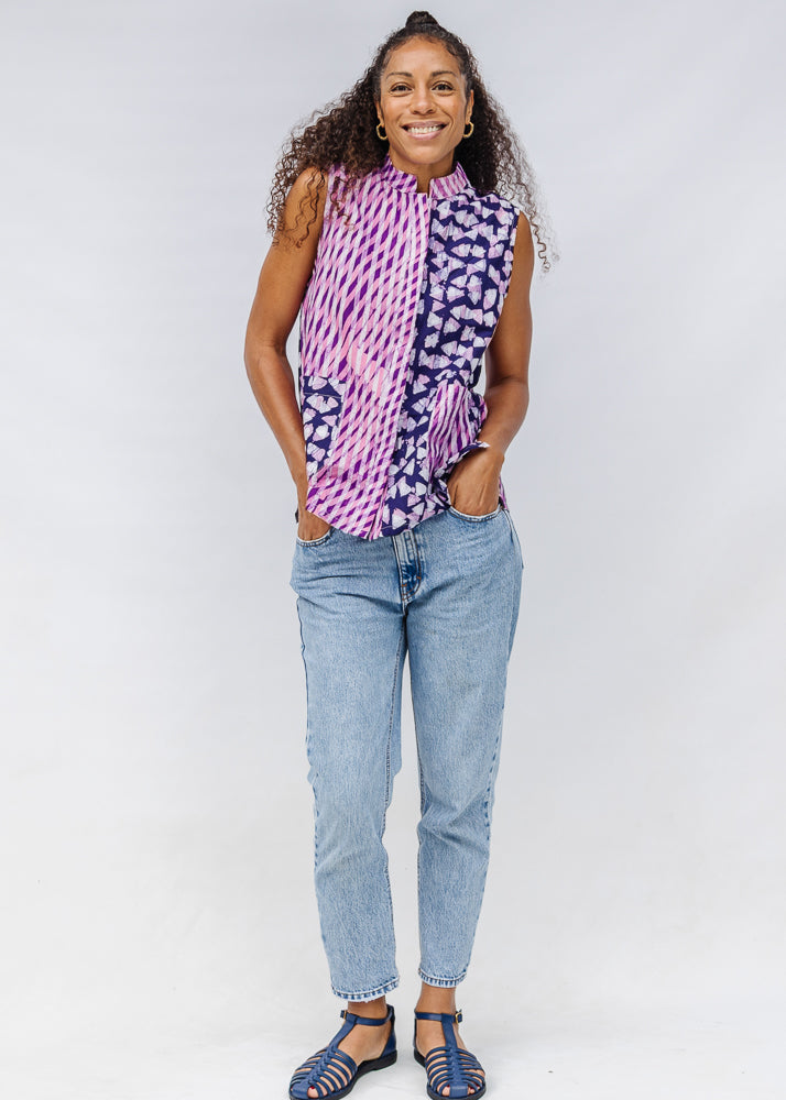 Model wearing purple, pink and white geometric print, patchwork sleeveless shirt.