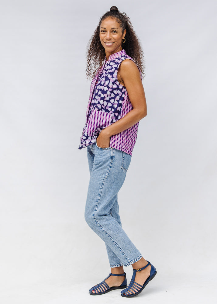 Model wearing purple, pink and white geometric print, patchwork sleeveless shirt.