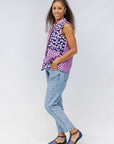 Model wearing purple, pink and white geometric print, patchwork sleeveless shirt.