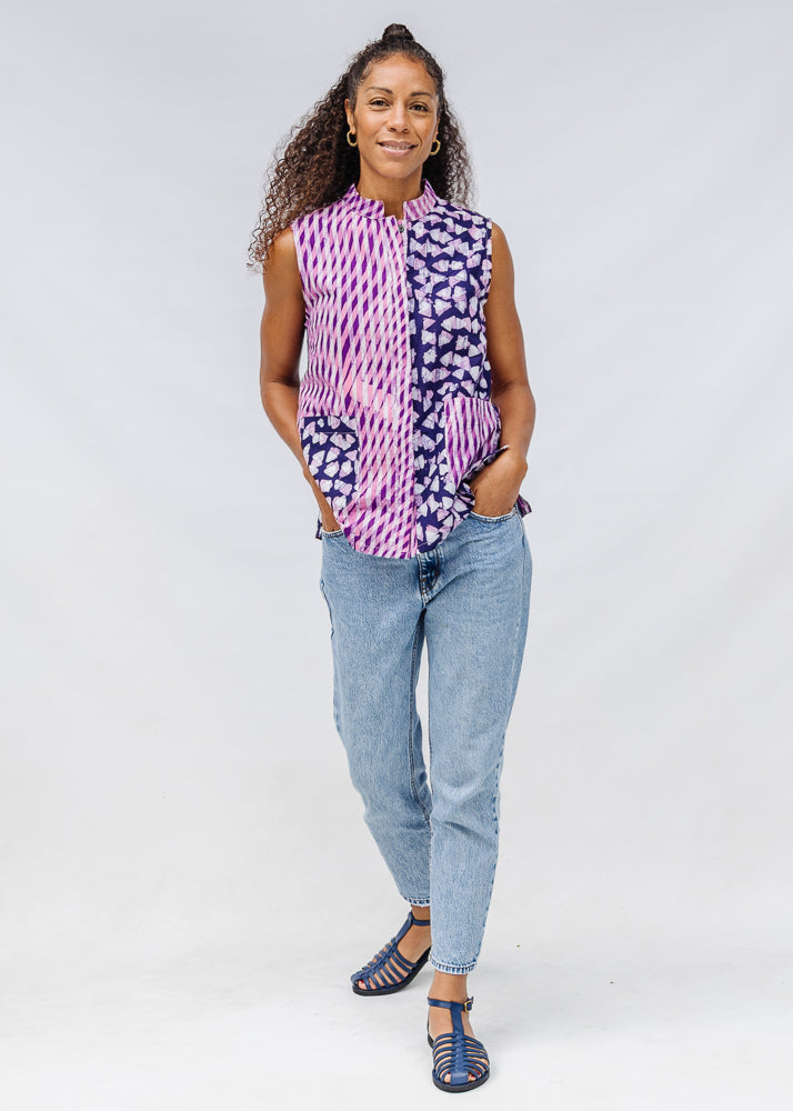 Model wearing purple, pink and white geometric print, patchwork sleeveless shirt.