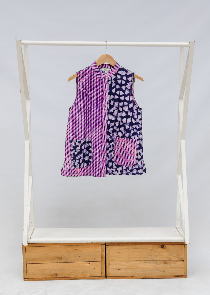 Display of purple, pink and white geometric print, patchwork sleeveless shirt.