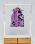 Display of purple, pink and white geometric print, patchwork sleeveless shirt.