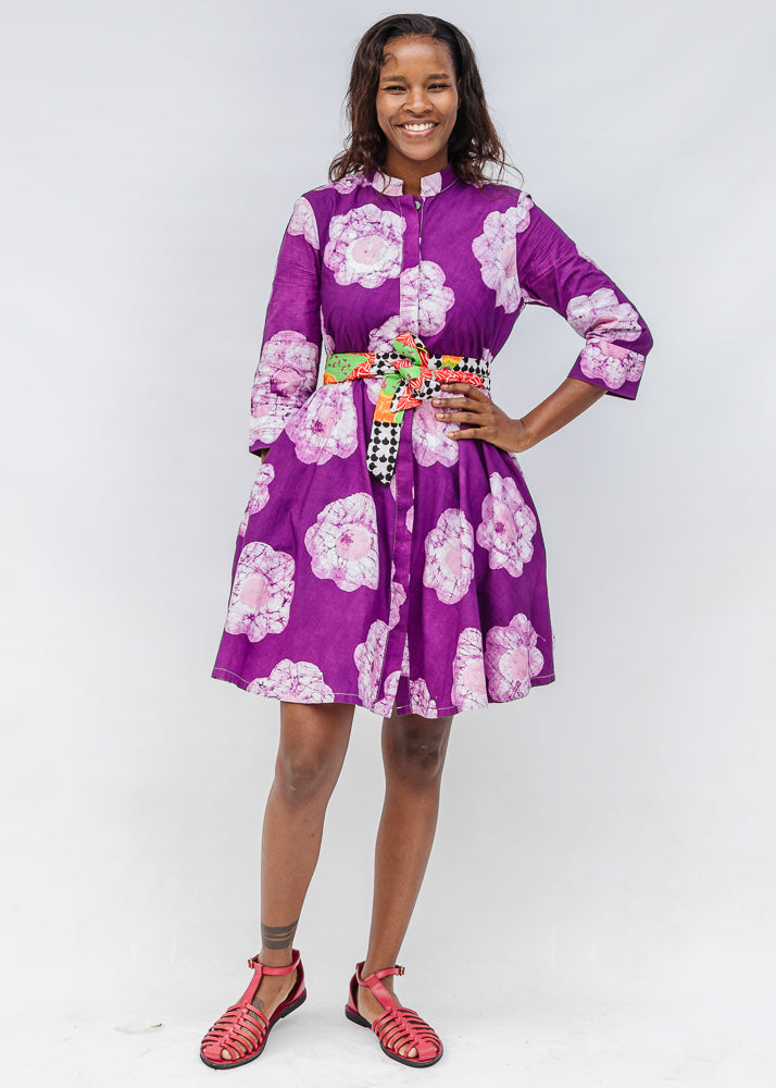 Model wearing purple and white floral print dress.