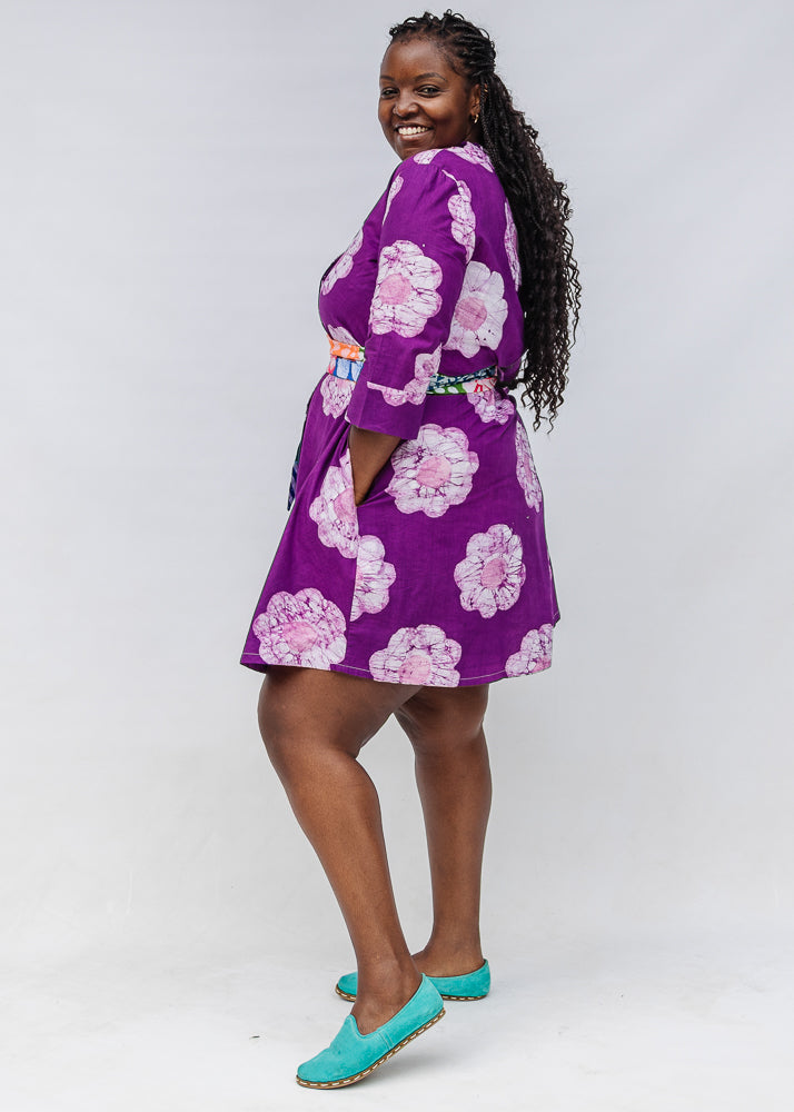 Model wearing purple and white floral print dress.