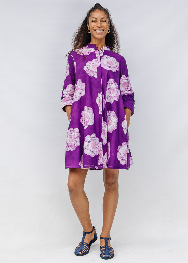 Model wearing purple and white floral print dress.