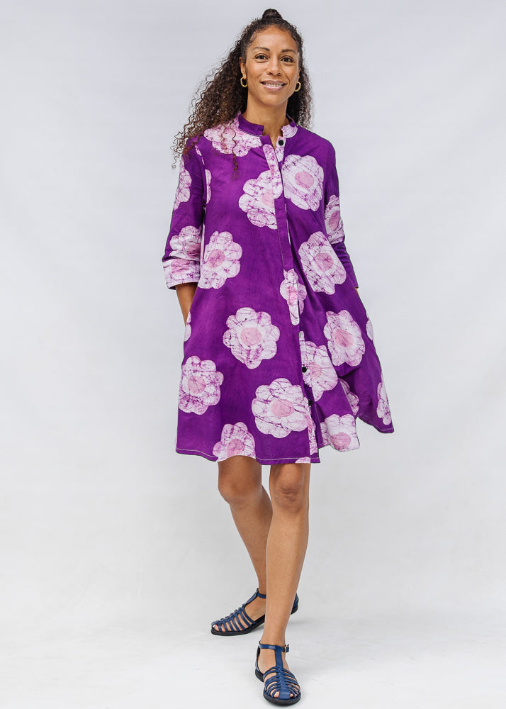 Model wearing purple and white floral print dress.
