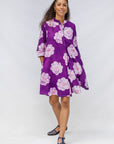 Model wearing purple and white floral print dress.