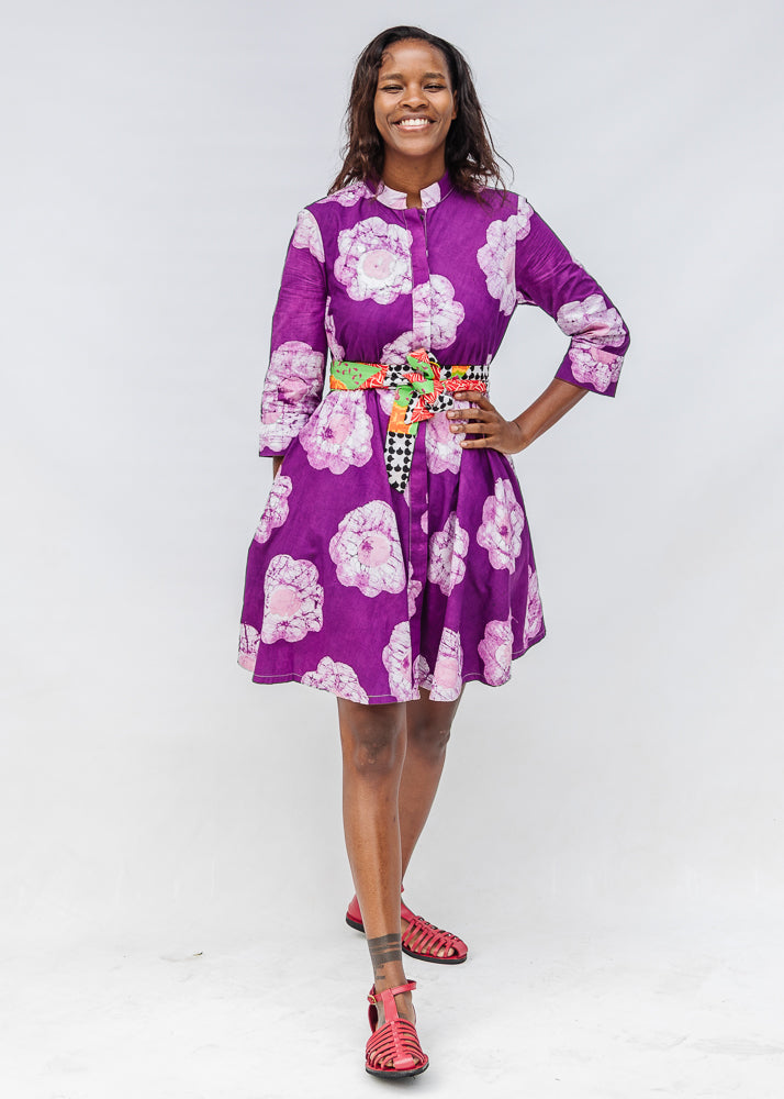 Model wearing purple and white floral print dress.