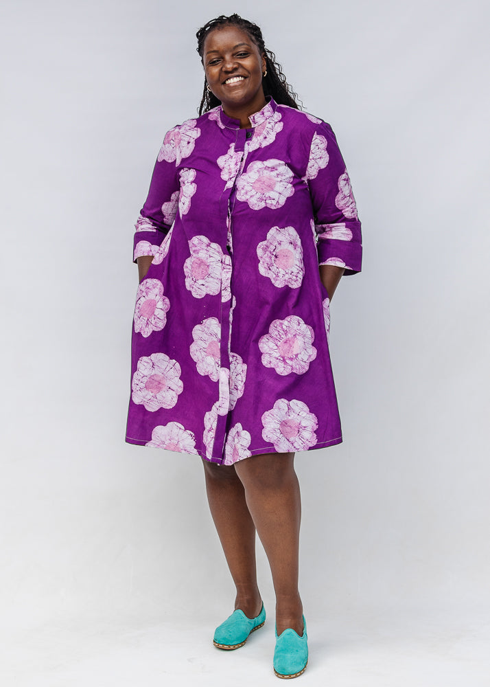 Model wearing purple and white floral print dress.