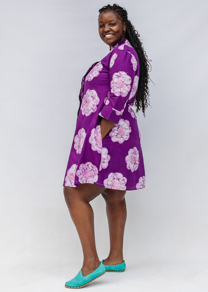 Model wearing purple and white floral print dress.