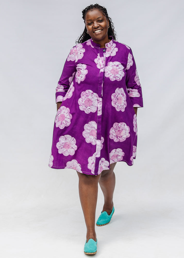 Model wearing purple and white floral print dress.