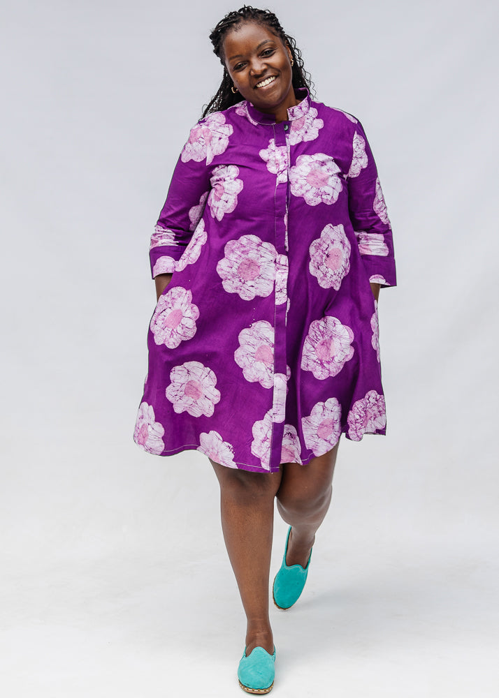 Model wearing purple and white floral print dress.