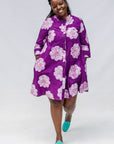 Model wearing purple and white floral print dress.